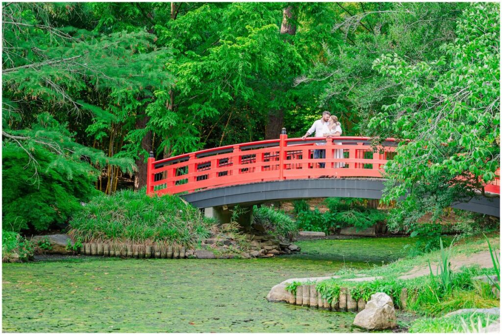 Kisses on the iconic red bridge at Duke Gardens