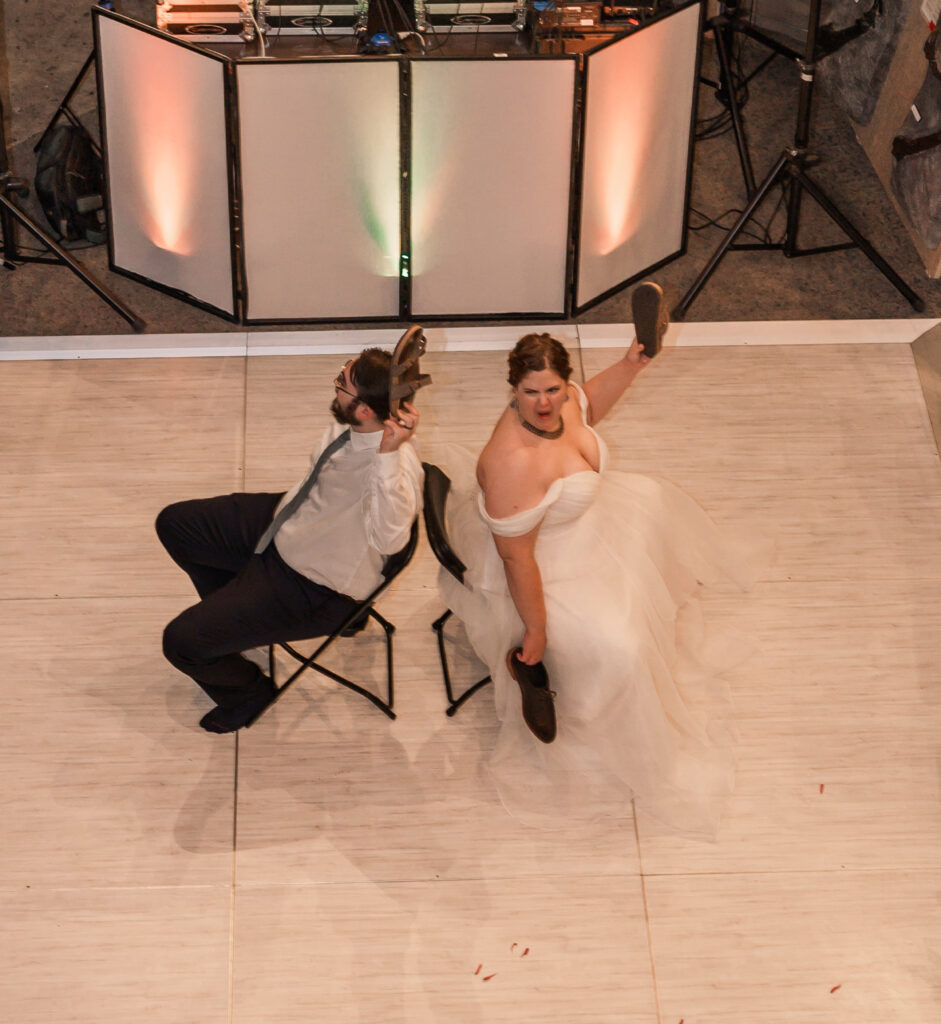 A happy couple celebrating their wedding reception at a Wilmington wedding venue by JoLynn Photography