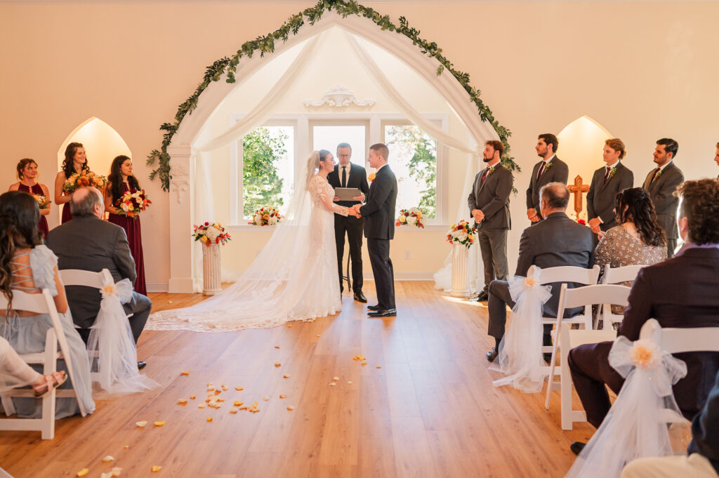 A bride and groom exchanging vows at the chapel at the Hudson Manor
