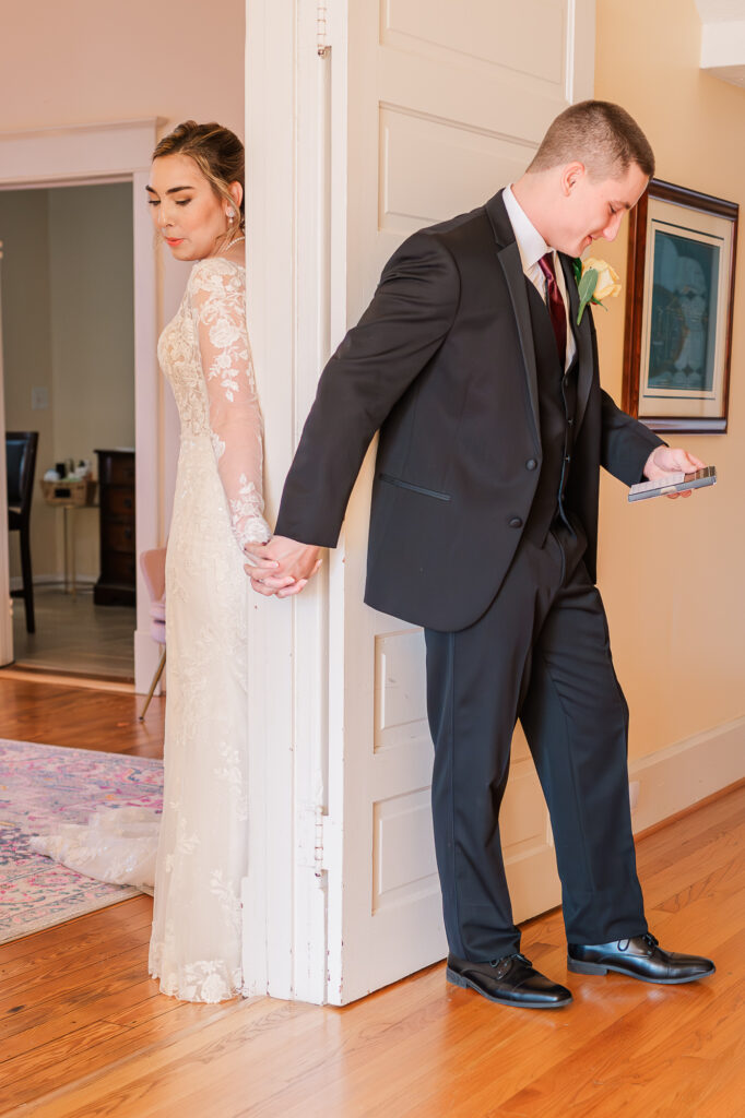 A bride and groom at the Hudson Manor having a first look in the hallway