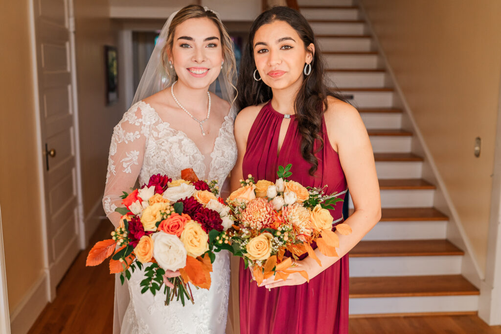 A happy bride and her maid of honor on her wedding day at the Hudson Manor