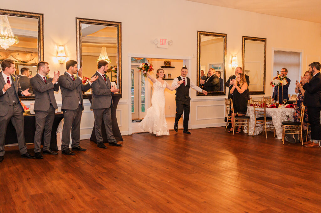 A bride and groom entering their reception at the Hudson Manor
