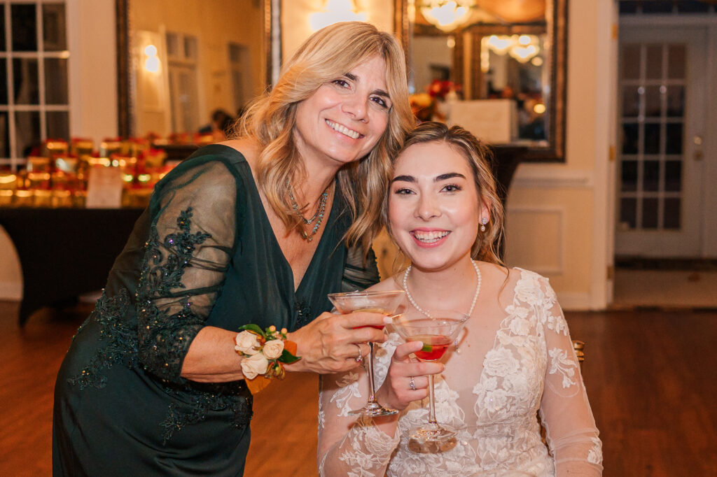 A bride and her mom celebrating at her wedding reception at the Hudson Manor