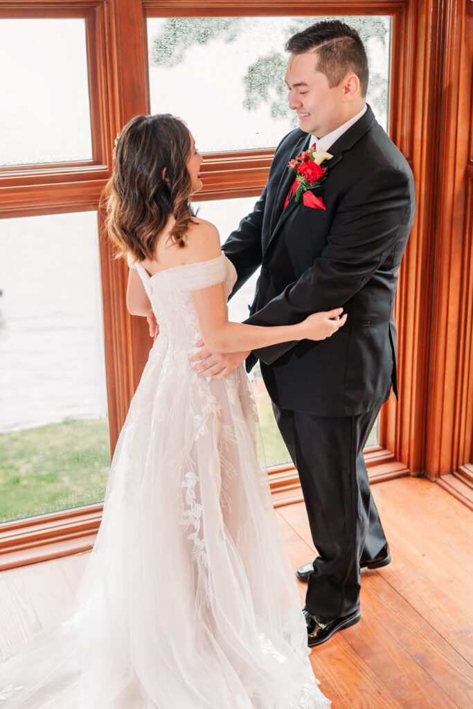 A bride and groom having a first look at their Lake Gaston Wedding by JoLynn Photography