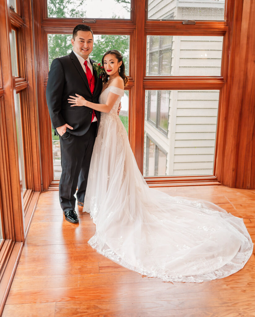 A happy couple embracing for their couples portraits at their Lake Gaston Wedding