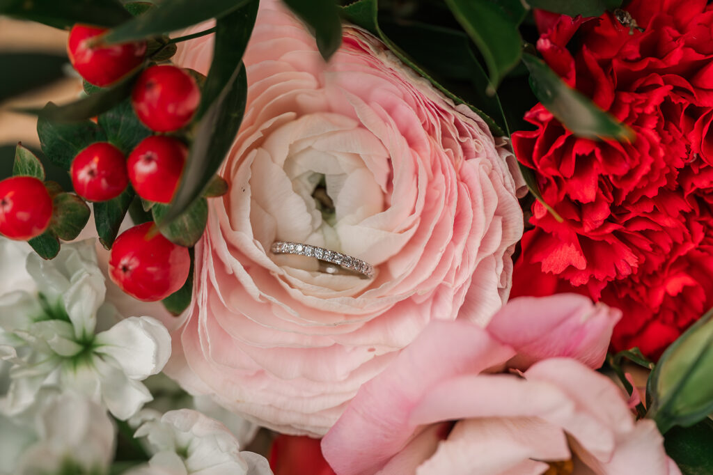 Beautiful wedding details of a bridal bouquet and a wedding band