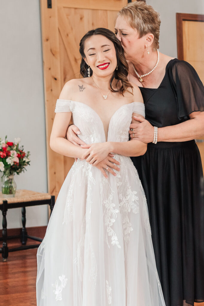 A loving mother celebrating her daughter's Lake Gaston Wedding day by JoLynn Photography