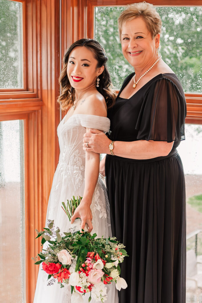 A happy mother and her daughter on her wedding day by JoLynn Photography