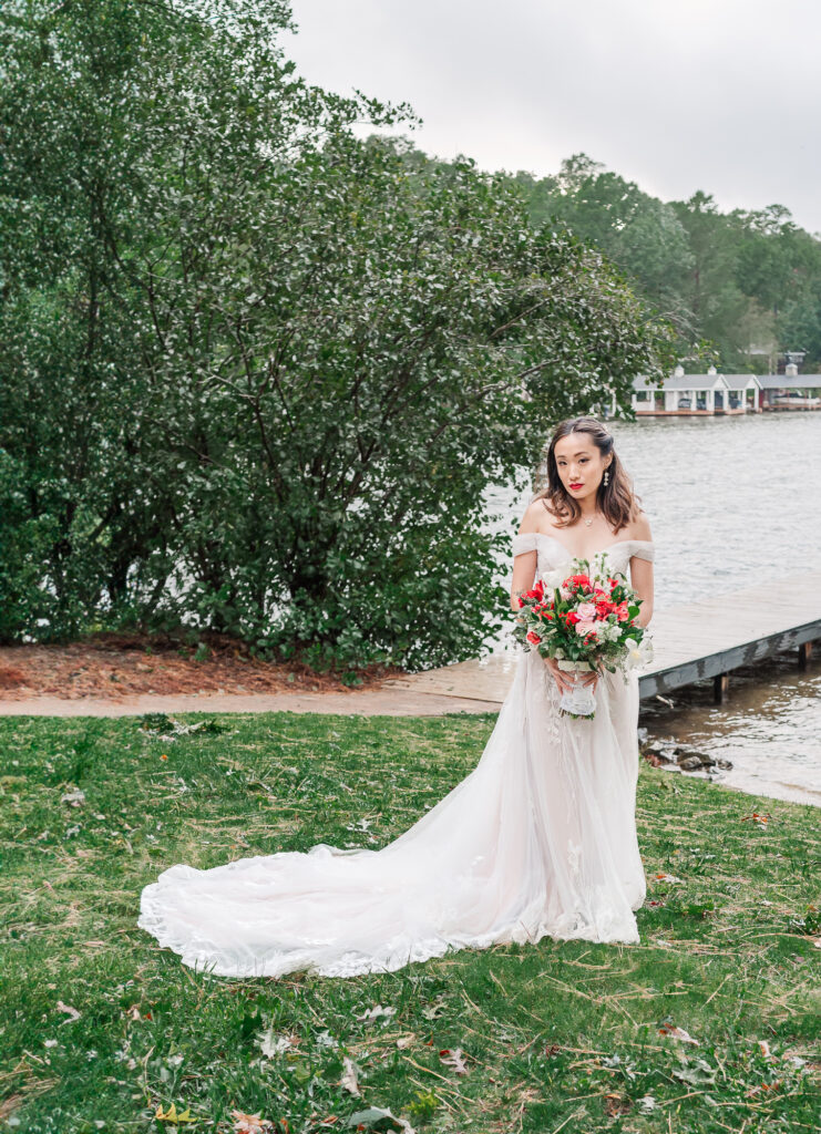 A glowing bride lakeside on her wedding day by JoLynn Photography