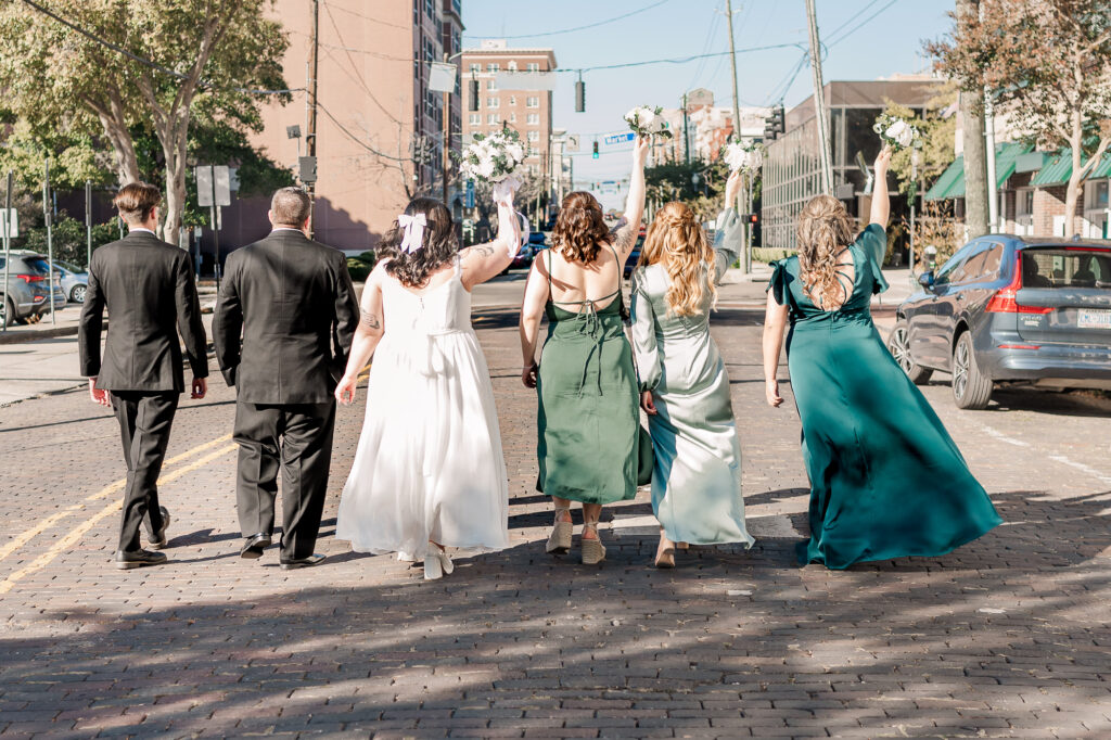 A bride and groom with their wedding party at their grand exit in downtown Wilmington
