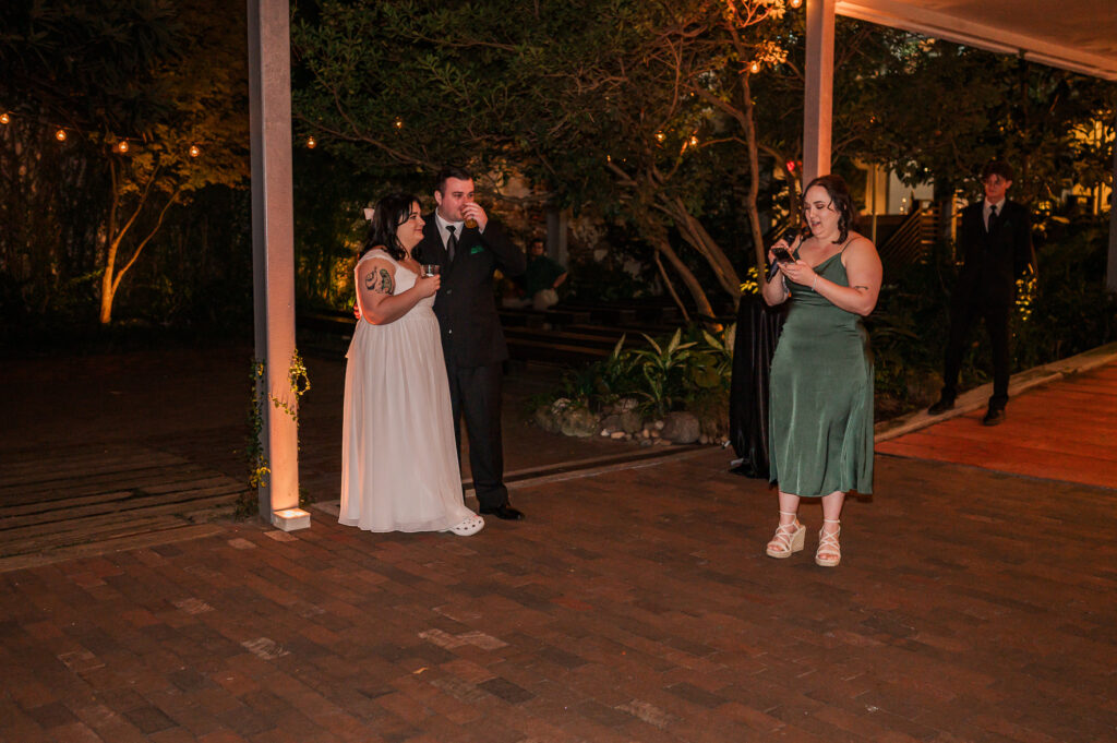 A maid of honor giving a speech to the bride and groom