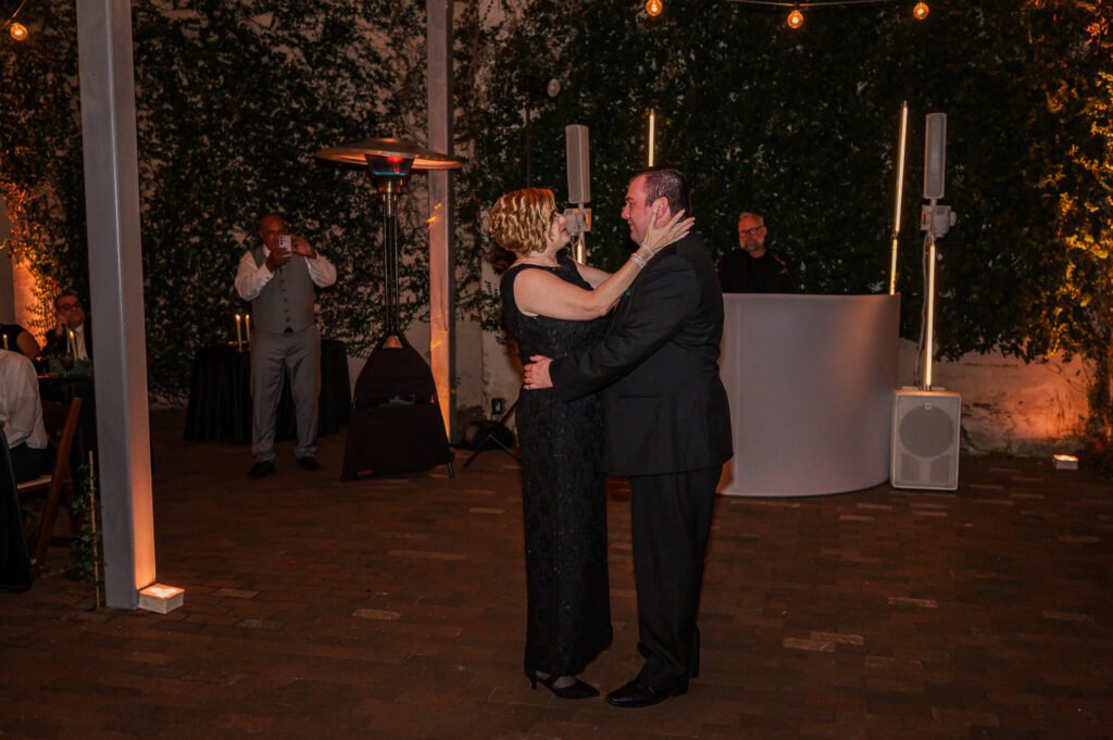 A mother and her son on his wedding day sharing a mother-son dance at The Atrium Wedding Venue by JoLynn Photography