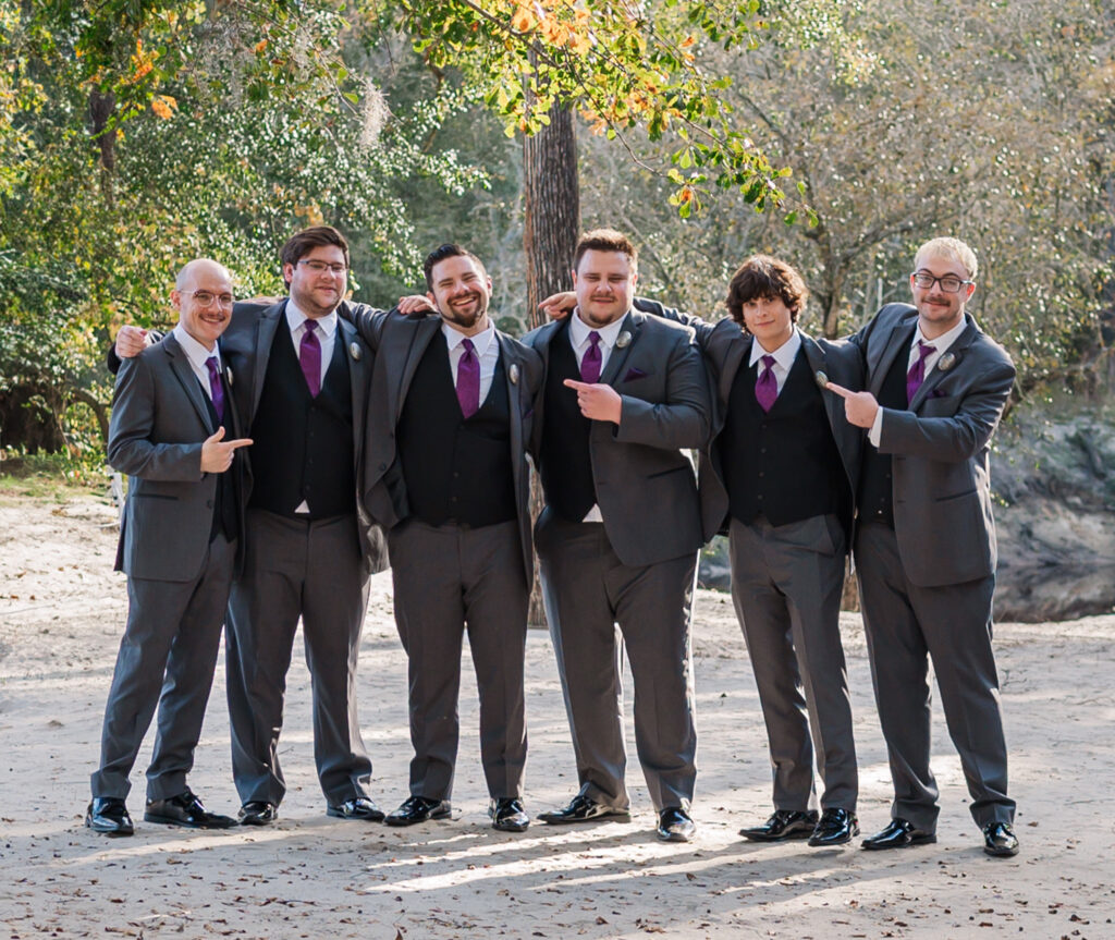A groom and his groomsmen celebrating after his wedding at the River Landing wedding venue