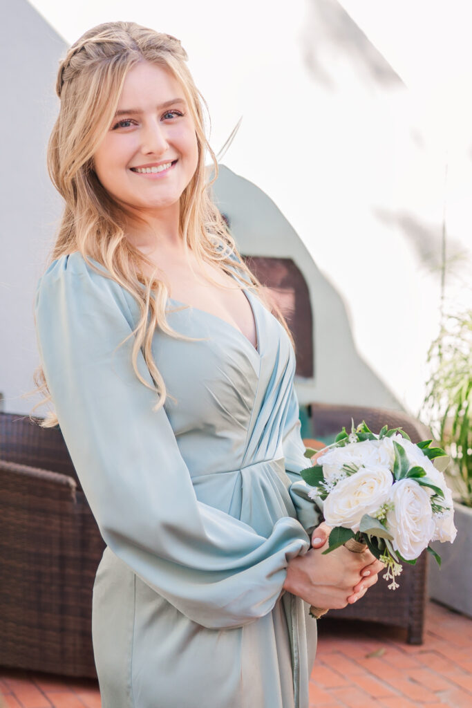 A pretty blond bridesmaid hanging out at The Atrium Wedding Venue