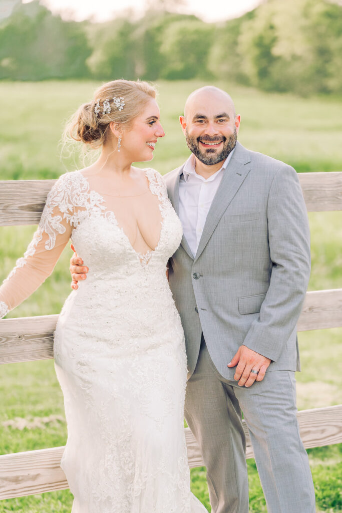 A couple at sunset after their wedding ceremony at Boots and Roots Farm by JoLynn Photography