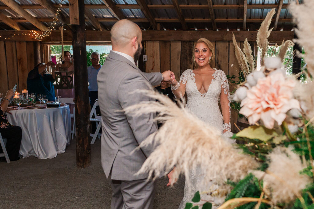 A newly married couple dancing at their wedding reception at Boots and Roots Farm