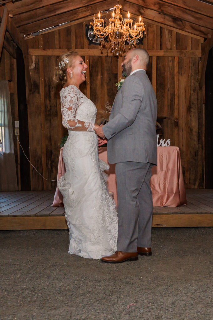 A couple enjoying their first dance at Boots and Roots Farm by JoLynn Photography