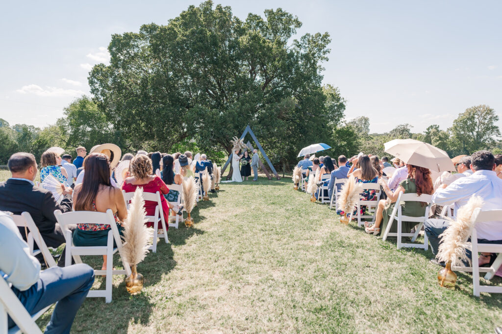 A bride and groom saying their vows at Boots and Roots Farm by JoLynn Photography