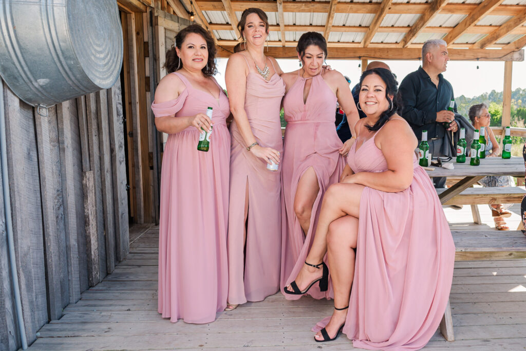Bridesmaids outside in July taking a break after dancing at Boots and Roots Farm by JoLynn Photography