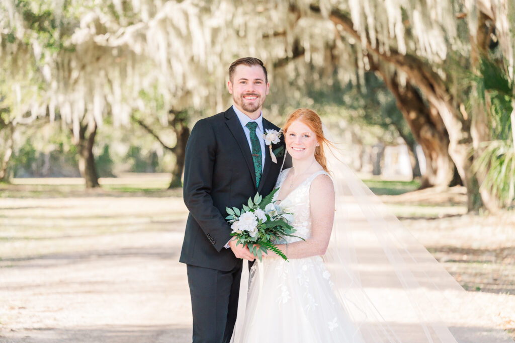 A married couple smiling at a  Savannah Destination Wedding by JoLynn Photography