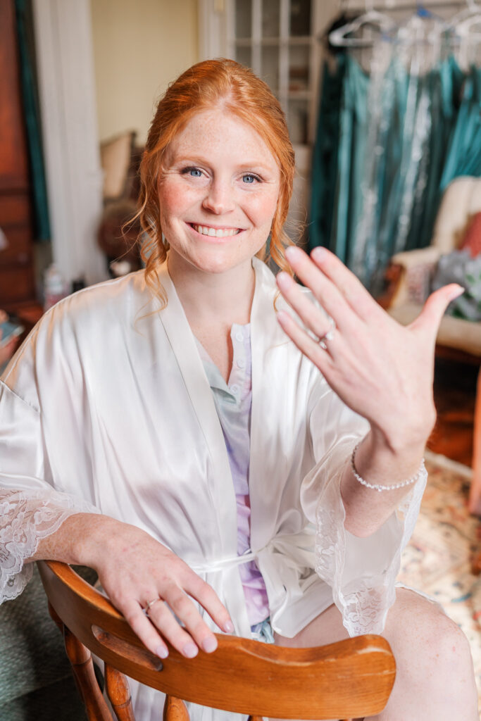 A bride showing off her engagement ring at Agapage Oaks by JoLynn Photography