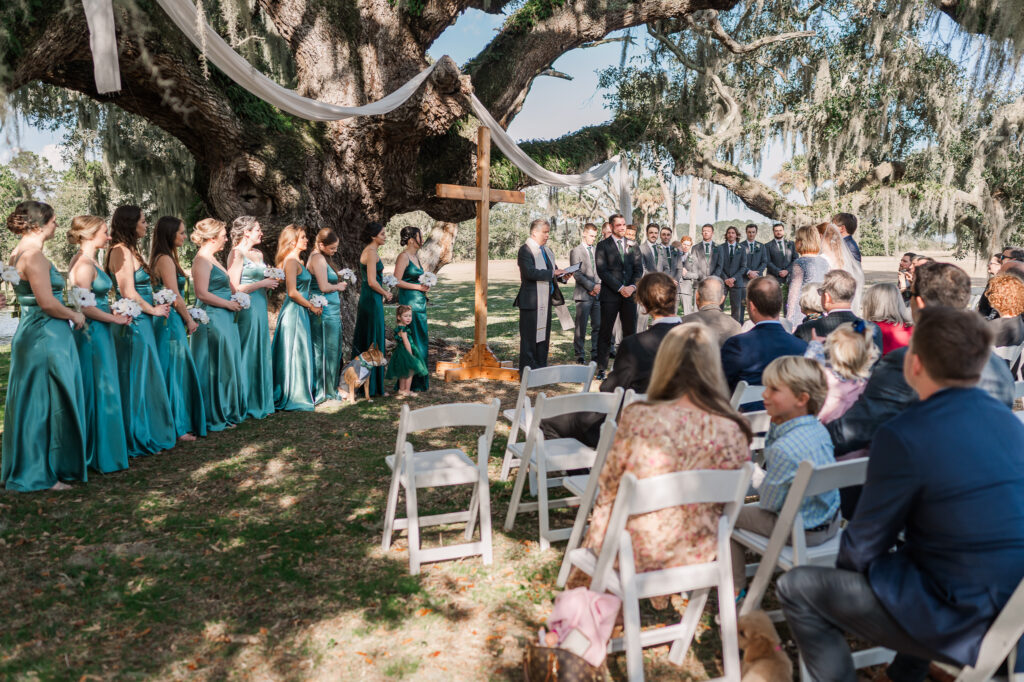 A wedding ceremony under Oak trees in Beaufort South Carolina by JoLynn photography