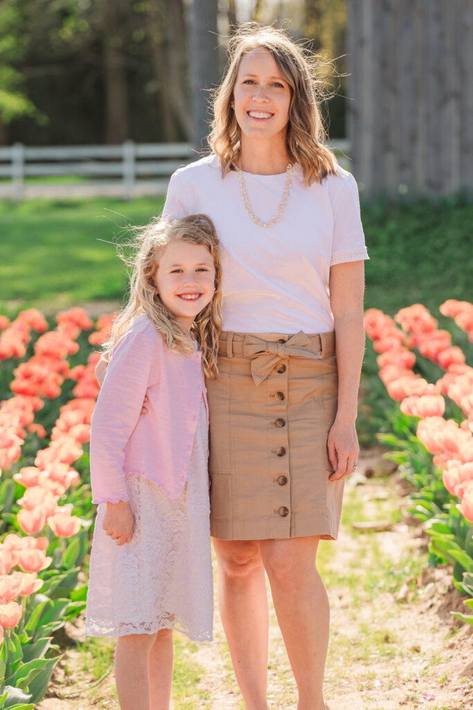 A loving mom and her daughter during spring family portraits in tulips by JoLynn Photography, a Greensboro family photographer