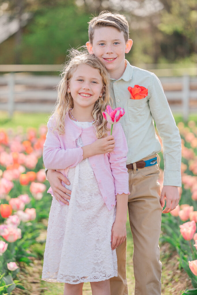 A brother and sister enjoying their spring family portraits at Dewberry Farms