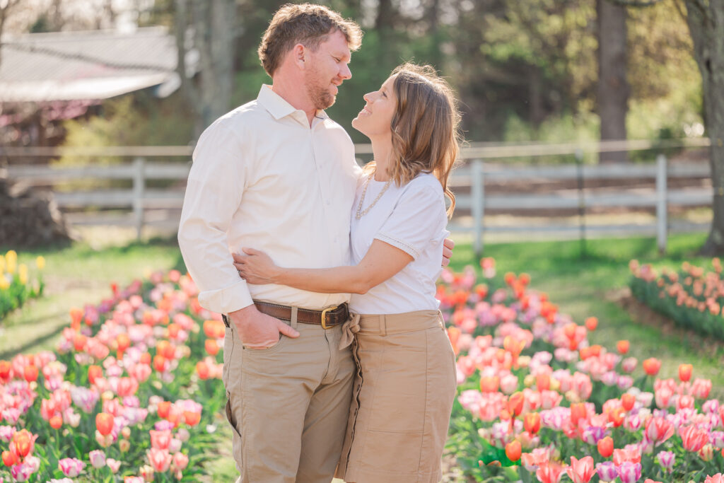 A husband and wife in love during a family spring session by JoLynn Photography, a Greensboro family photographer
