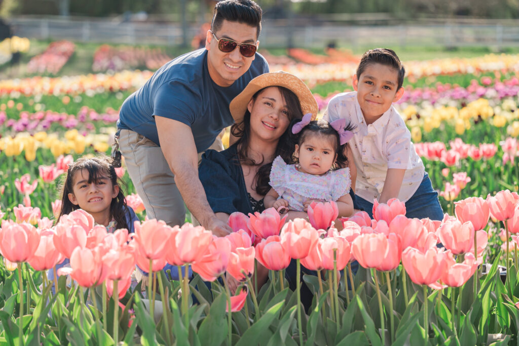 A loving family in endless spring tulips enjoying their Wake Forest family photography session