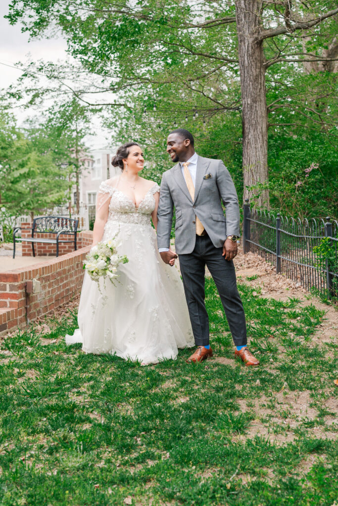 A bride and groom in a downtown Wake Forest garden enjoying their wedding day planned by their Wake Forest wedding planner