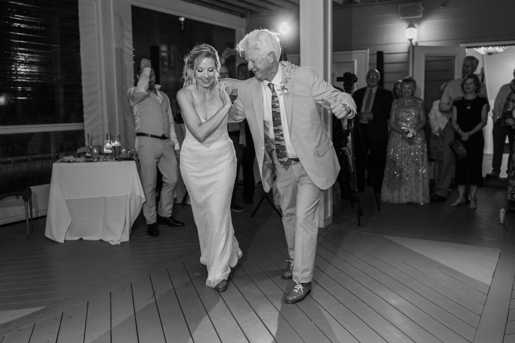 A bride and her dad dancing at the end of her wedding reception by JoLynn Photography
