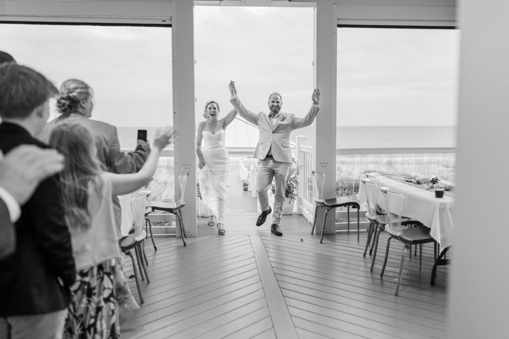 A bride and groom entering their wedding reception on Atlantic Beach
