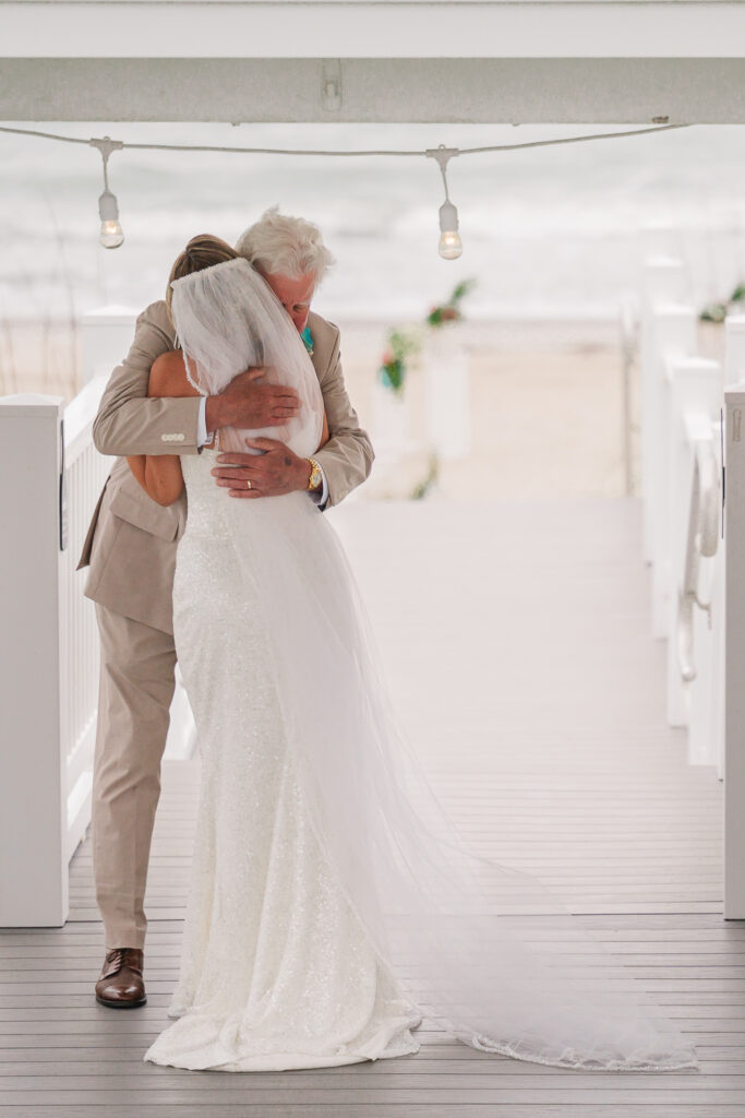 A father and daughter first look at her Atlantic beach wedding by JoLynn Photography