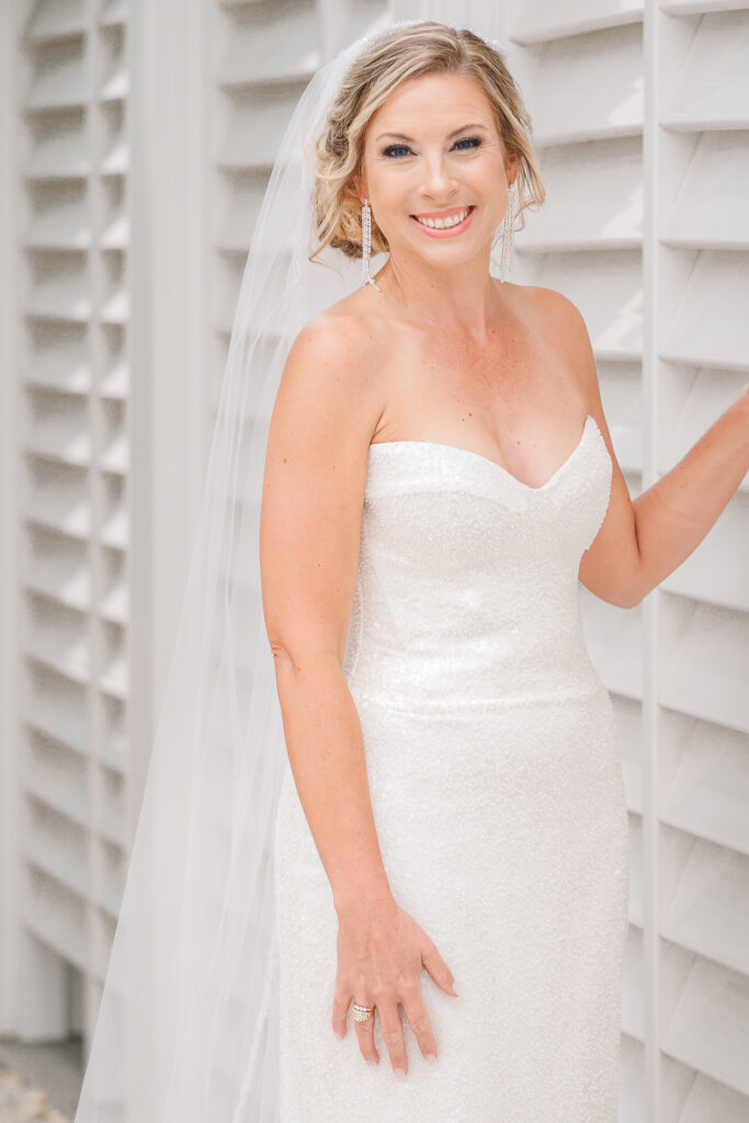 A happy blonde bride on her wedding day during her bridal portraits at the Atlantic beach wedding by JoLynn Photography