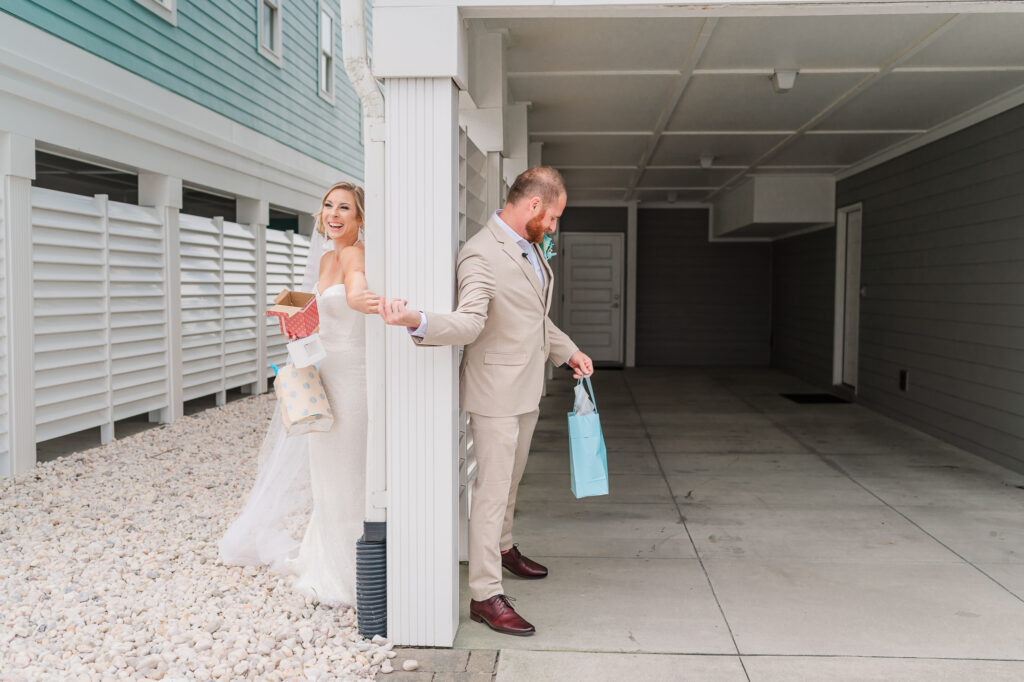 A bride and groom exchanging gifts during a first touch at the Atlantic beach wedding by JoLynn Photography