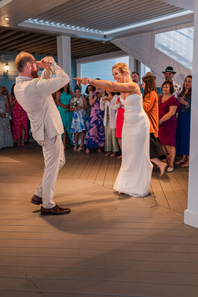 A newly married bride and groom dancing at their wedding reception by JoLynn Photography