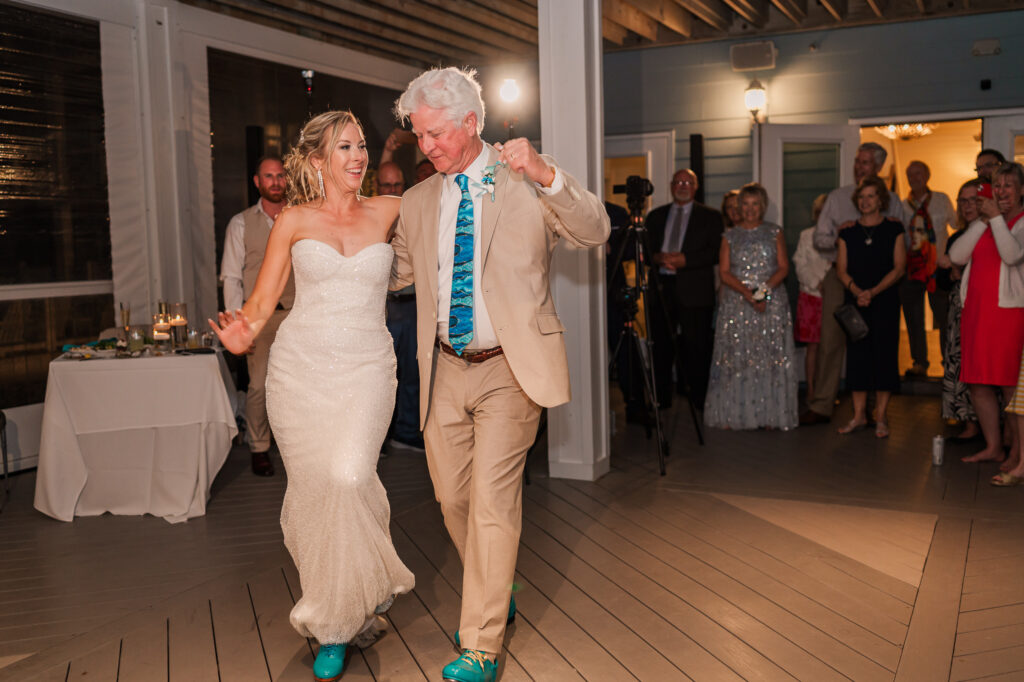 A father and his daughter dancing polka at her Atlantic beach wedding by JoLynn Photography
