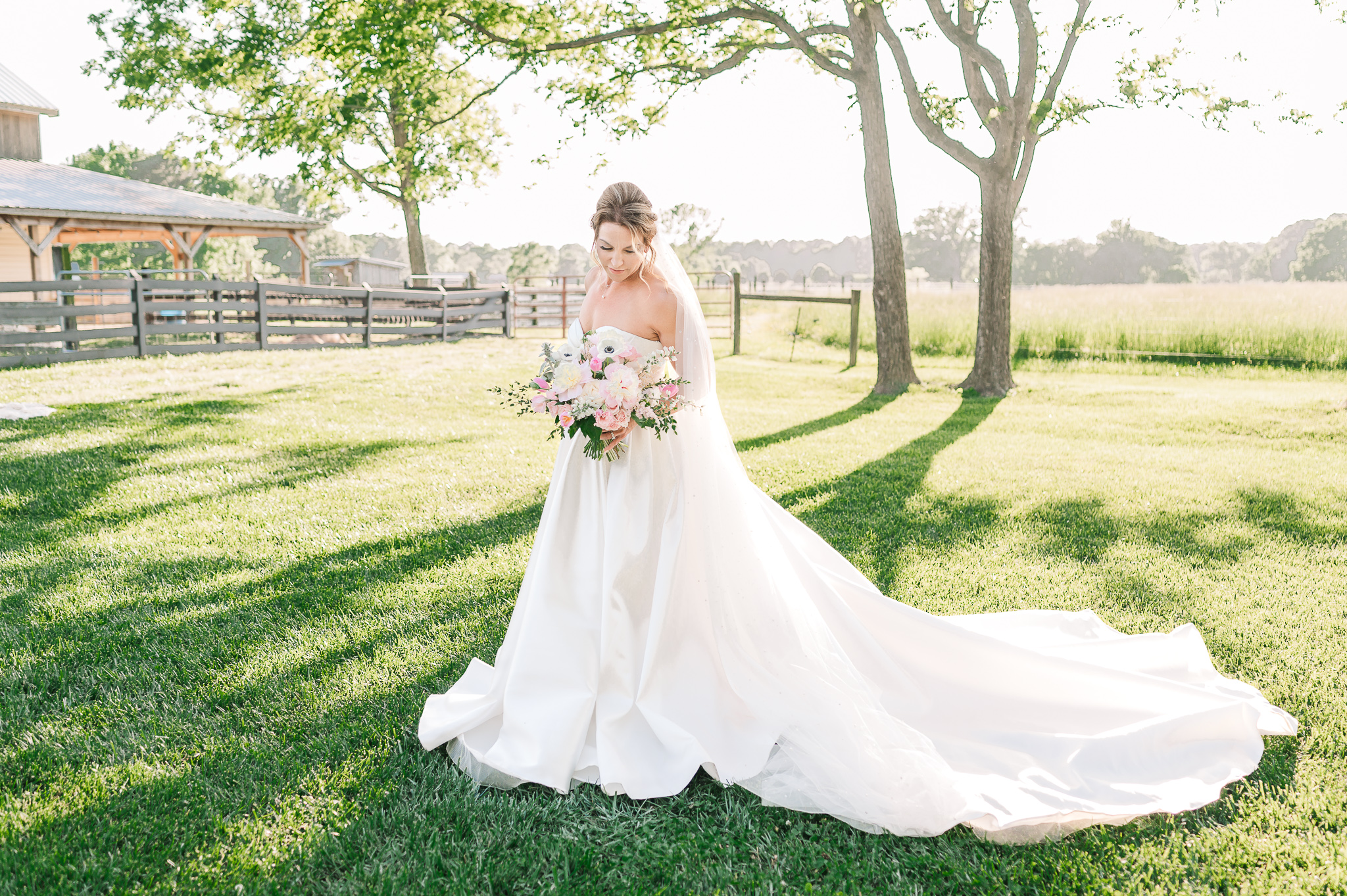 A happy brunette bride during her bridal portrait session at sunset at Highrock Farms by JoLynn Photography