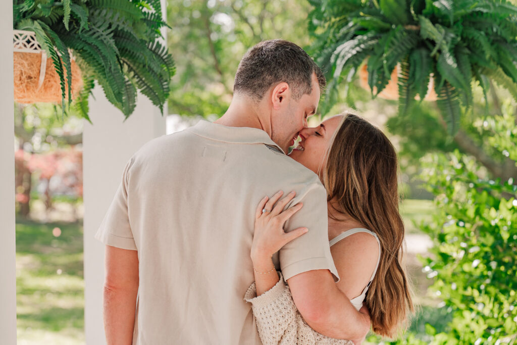 A couple embracing and kissing during a spring afternoon enjoying their Sycamore Bend engagement session