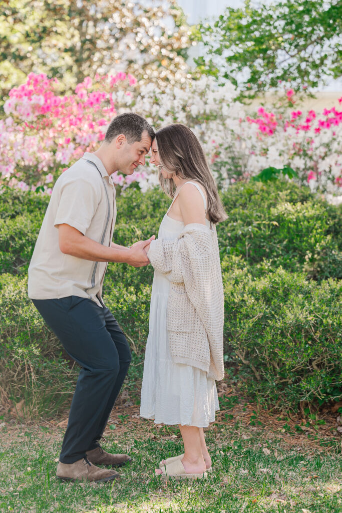 A couple touching forehead to forehead and laughing about a height difference during their Sycamore Bend engagement session by JoLynn Photography