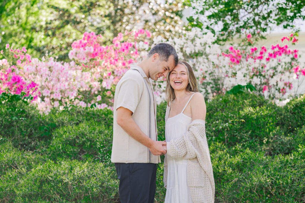 A newly engaged couple laughing about a height difference in their Sycamore Bend engagement photos by JoLynn Photography