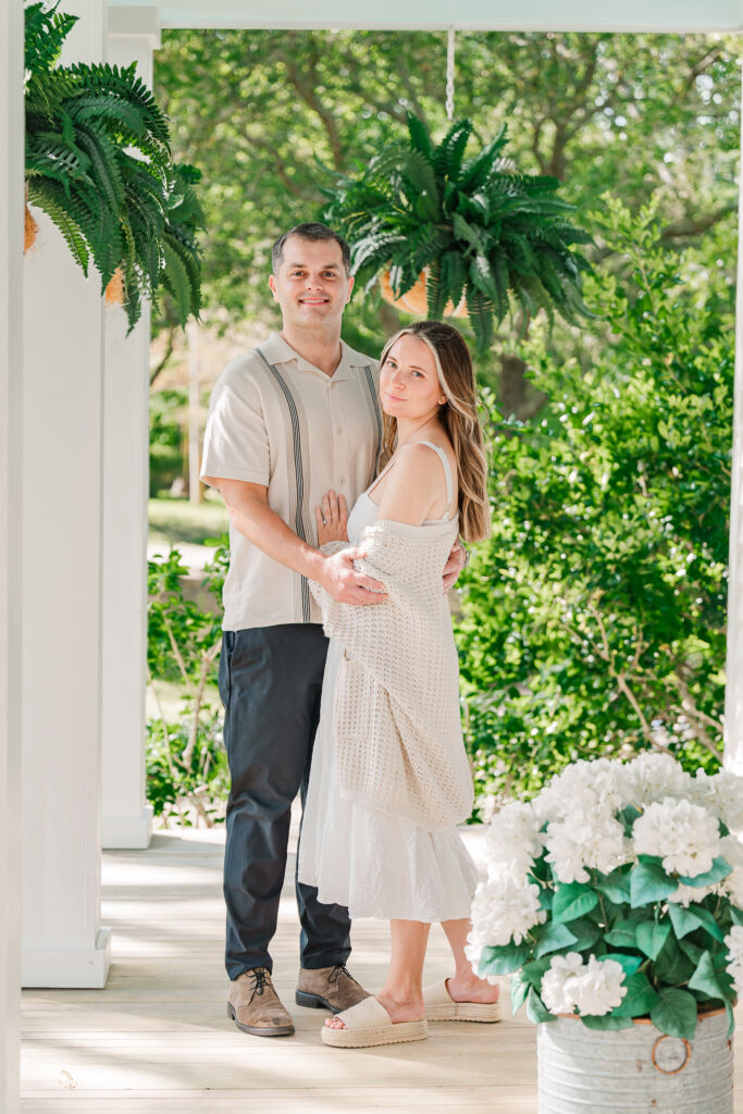 A newly engaged couple on the porch of Sycamore Bend enjoying their engagement by JoLynn Photography