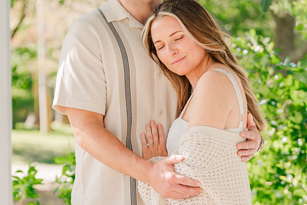 A newly engagement partner embracing her soon to be husband during the Sycamore Bend engagement by Jolynn Photography
