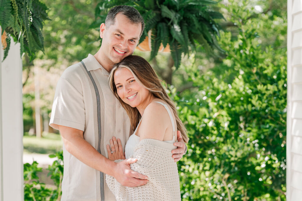 A newly engaged couple laughing during their Sycamore Bend engagement during a spring afternoon by JoLynn Photography