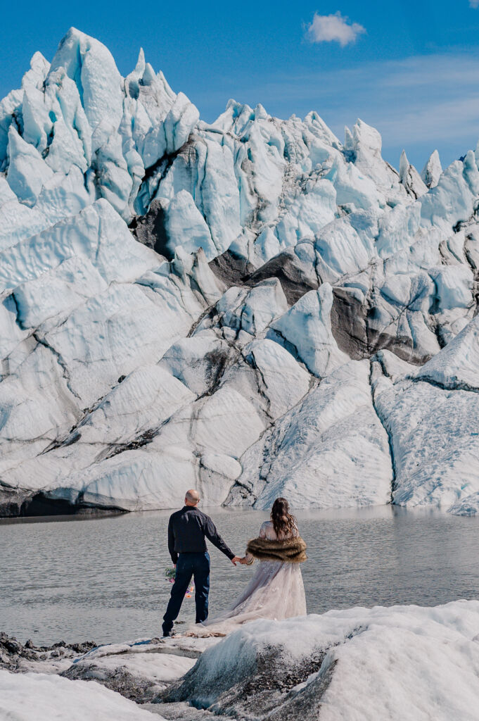 A couple enjoying their destination wedding on Matanuska Glacier for their Alaskan Glacier Wedding by destination wedding photographer, JoLynn Photography