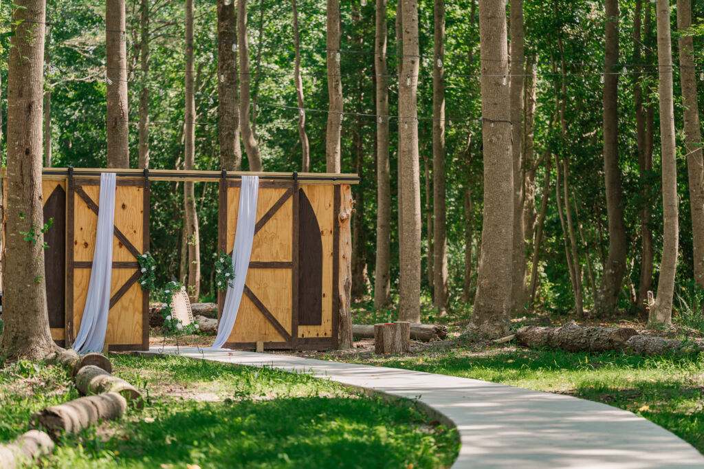 A double wooden doorway of an outdoor wedding ceremony at The English Country Barn