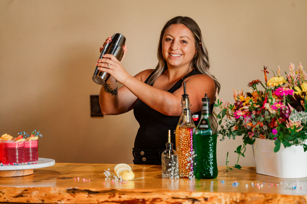 A happy bartender mixing drinks at The English Country Barn