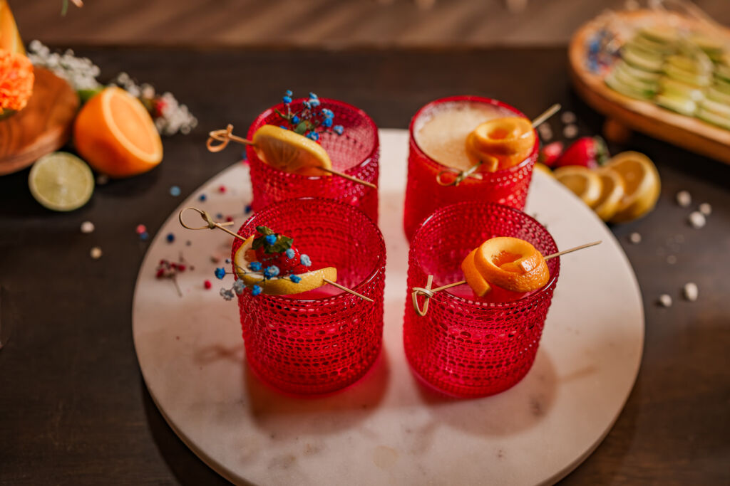 Handmixed cocktails in red glasses at The English Country Barn by JoLynn Photography