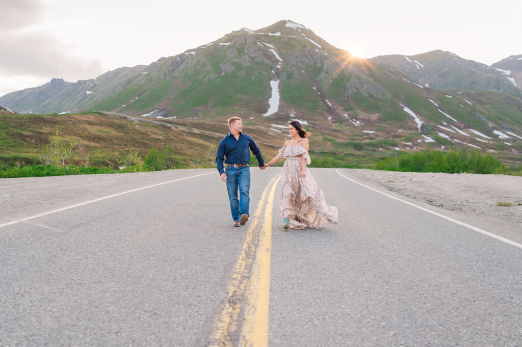 A happily engaged couple celebrating their summer Alaska engagement photos during the midnight sun at Hatchers Pass by Destination wedding photographer, JoLynn Photography